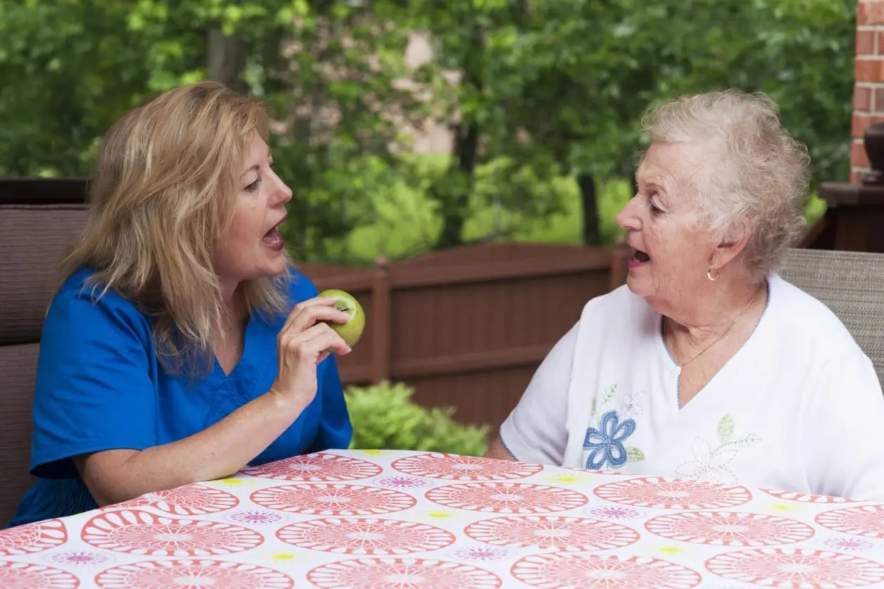 senior woman speaking with healthcare professional